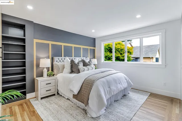 a spacious bedroom with a large bed and a large window