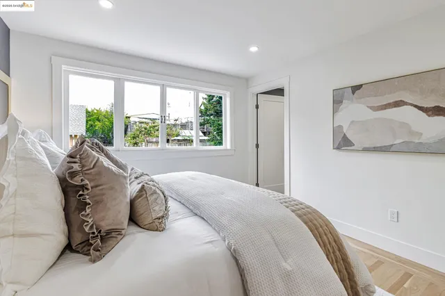 a bed sitting in a bedroom next to a window
