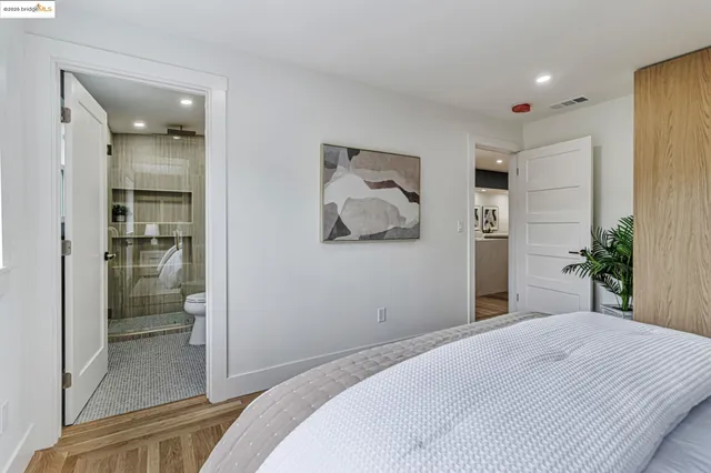a bedroom with a bed and glass door