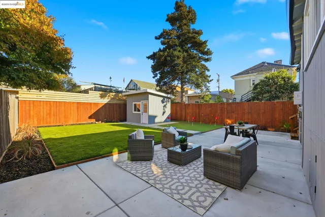 a view of a backyard with furniture and a garden