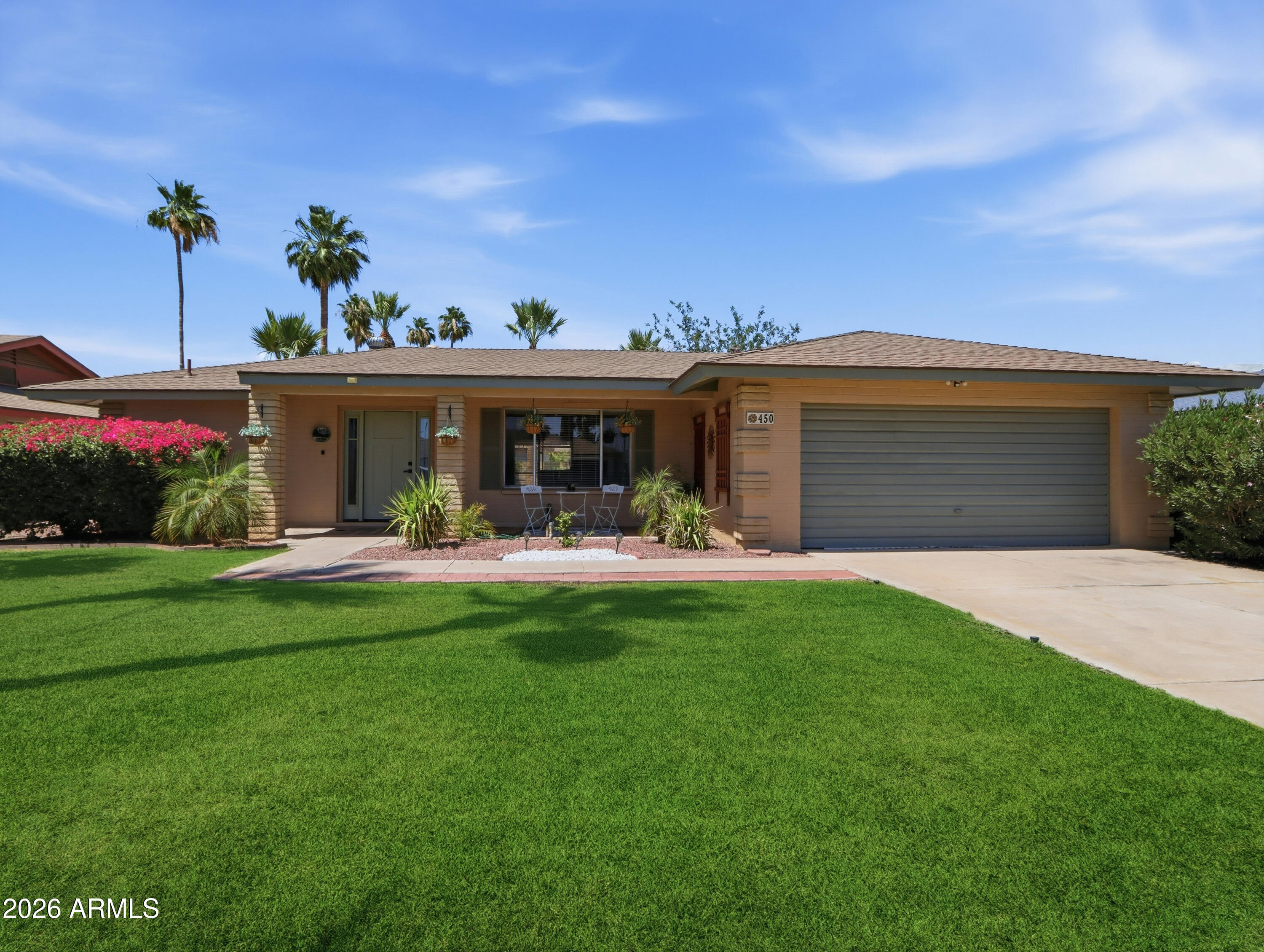 450 Cascada Road Litchfield Park, AZ 85340 - Photo 1 of 40 a view of a house with a yard porch and sitting area
