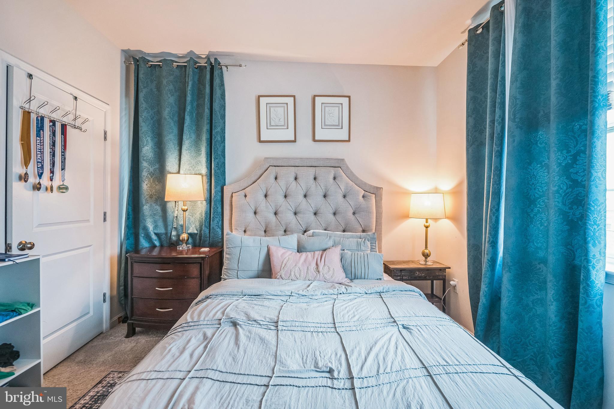 7041 Freedom Way Frederick, MD 21703 - Photo 12 of 32 a bedroom with a large bed and a chandelier