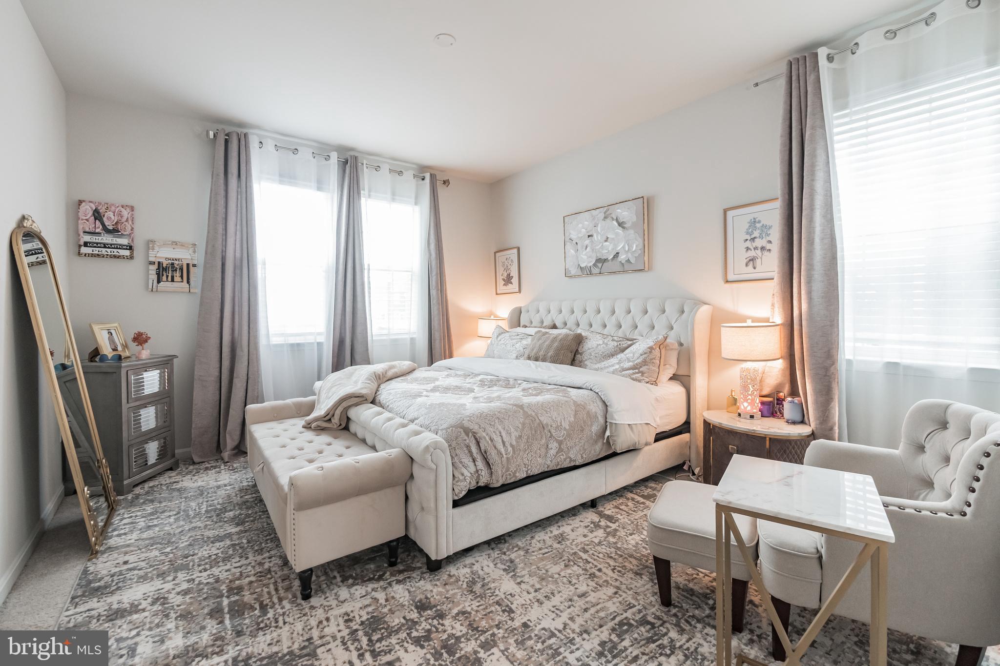 7041 Freedom Way Frederick, MD 21703 - Photo 13 of 32 a bedroom with a bed a couch and a window