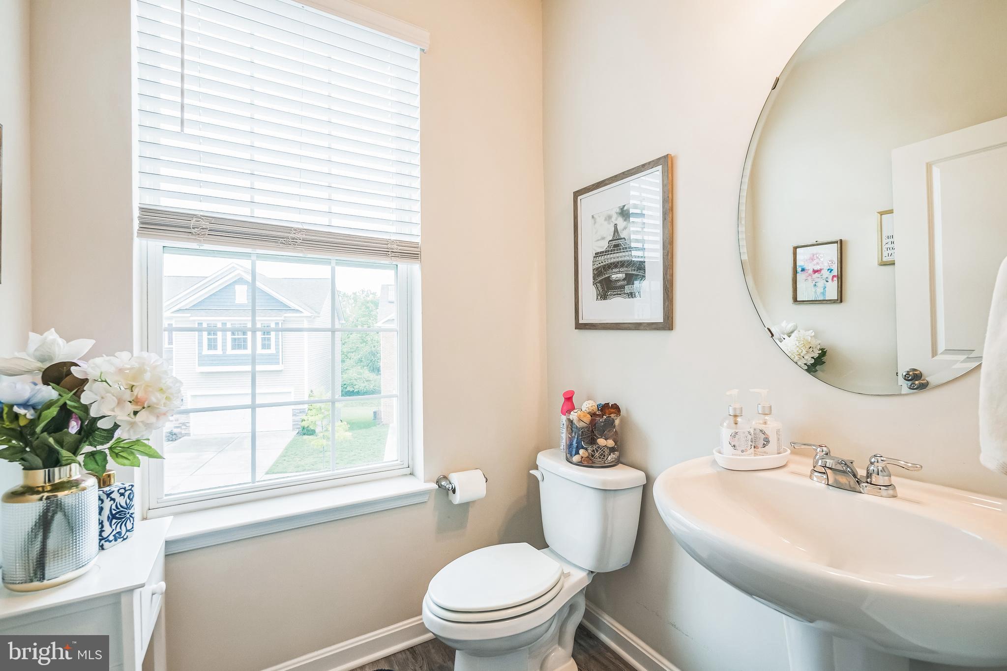 7041 Freedom Way Frederick, MD 21703 - Photo 17 of 32 a bathroom with a toilet sink and mirror