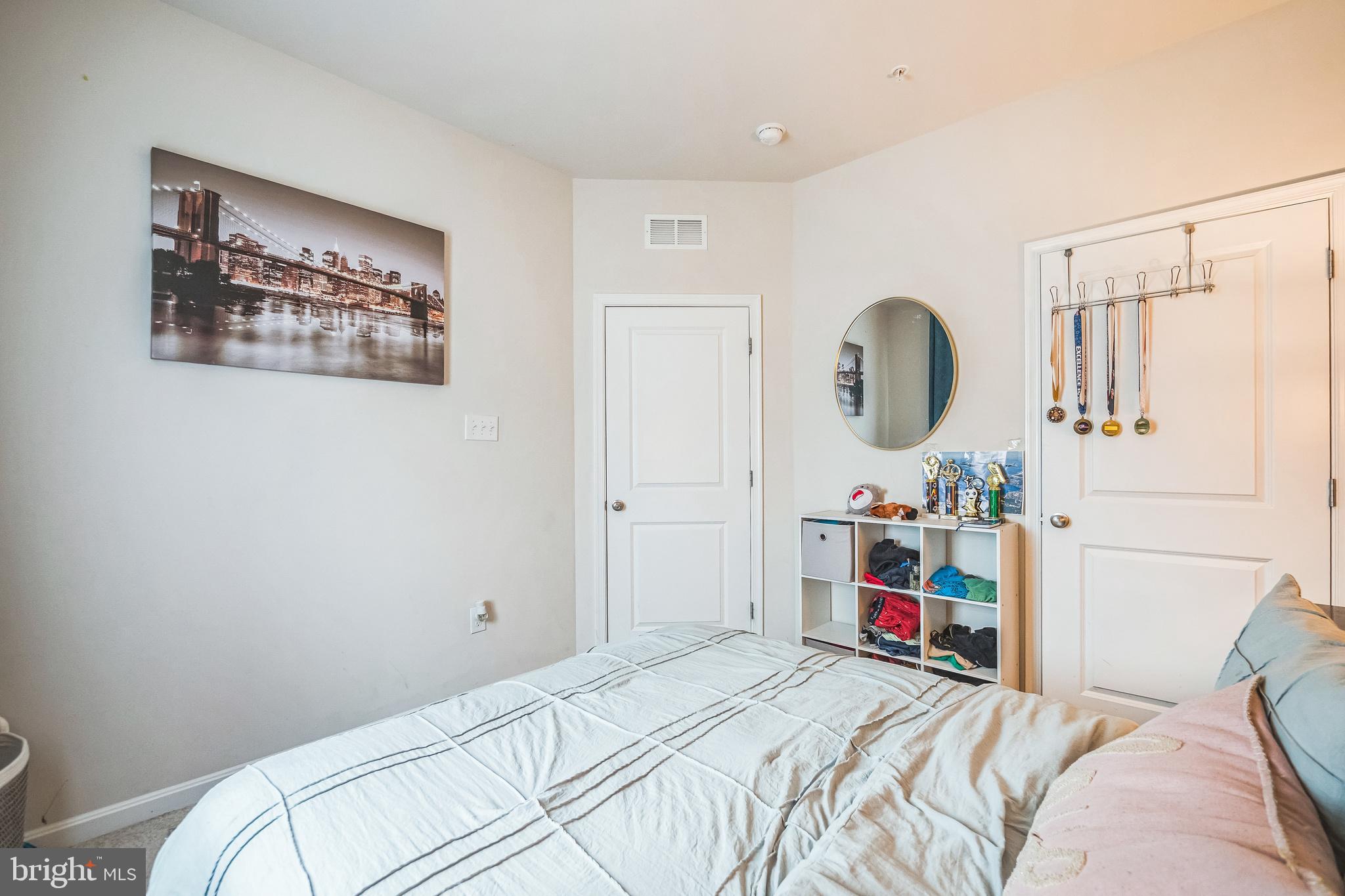 7041 Freedom Way Frederick, MD 21703 - Photo 22 of 32 a bedroom with bed and a chandelier