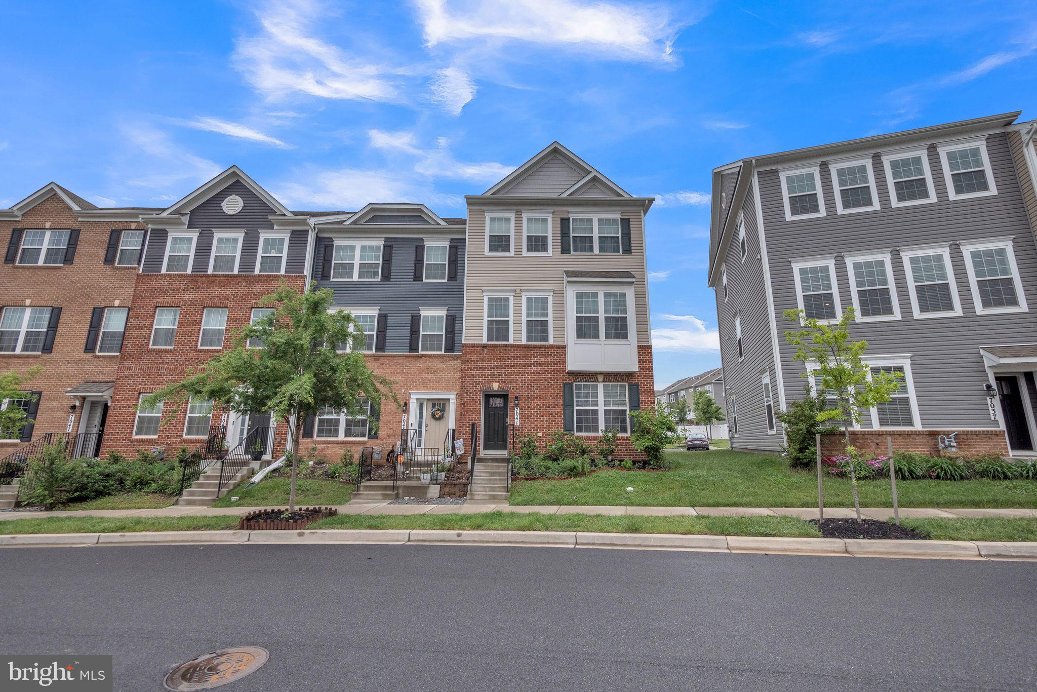 7041 Freedom Way Frederick, MD 21703 - Photo 25 of 32 a front view of a residential apartment building with a yard