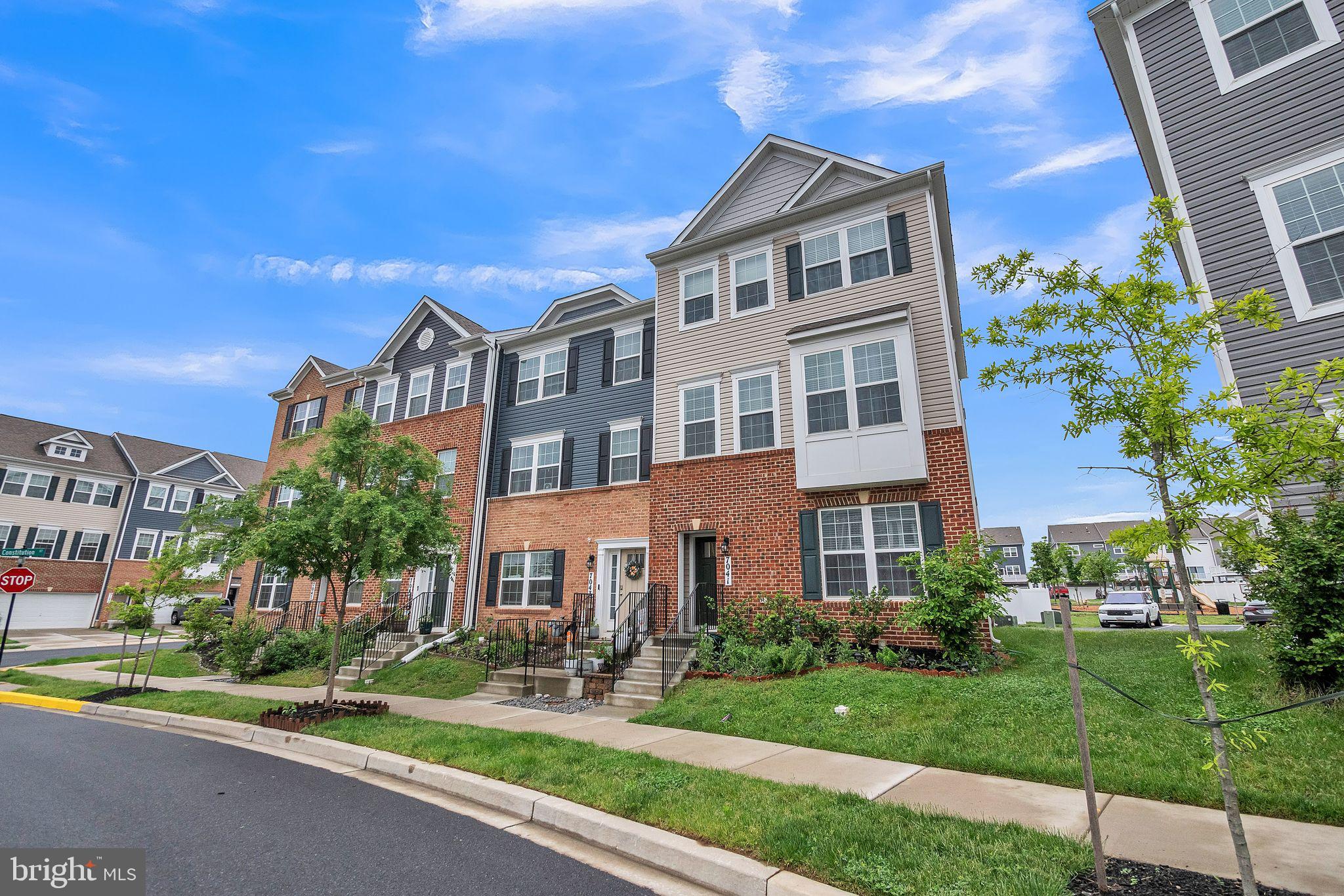 7041 Freedom Way Frederick, MD 21703 - Photo 26 of 32 a front view of a building with garden and trees