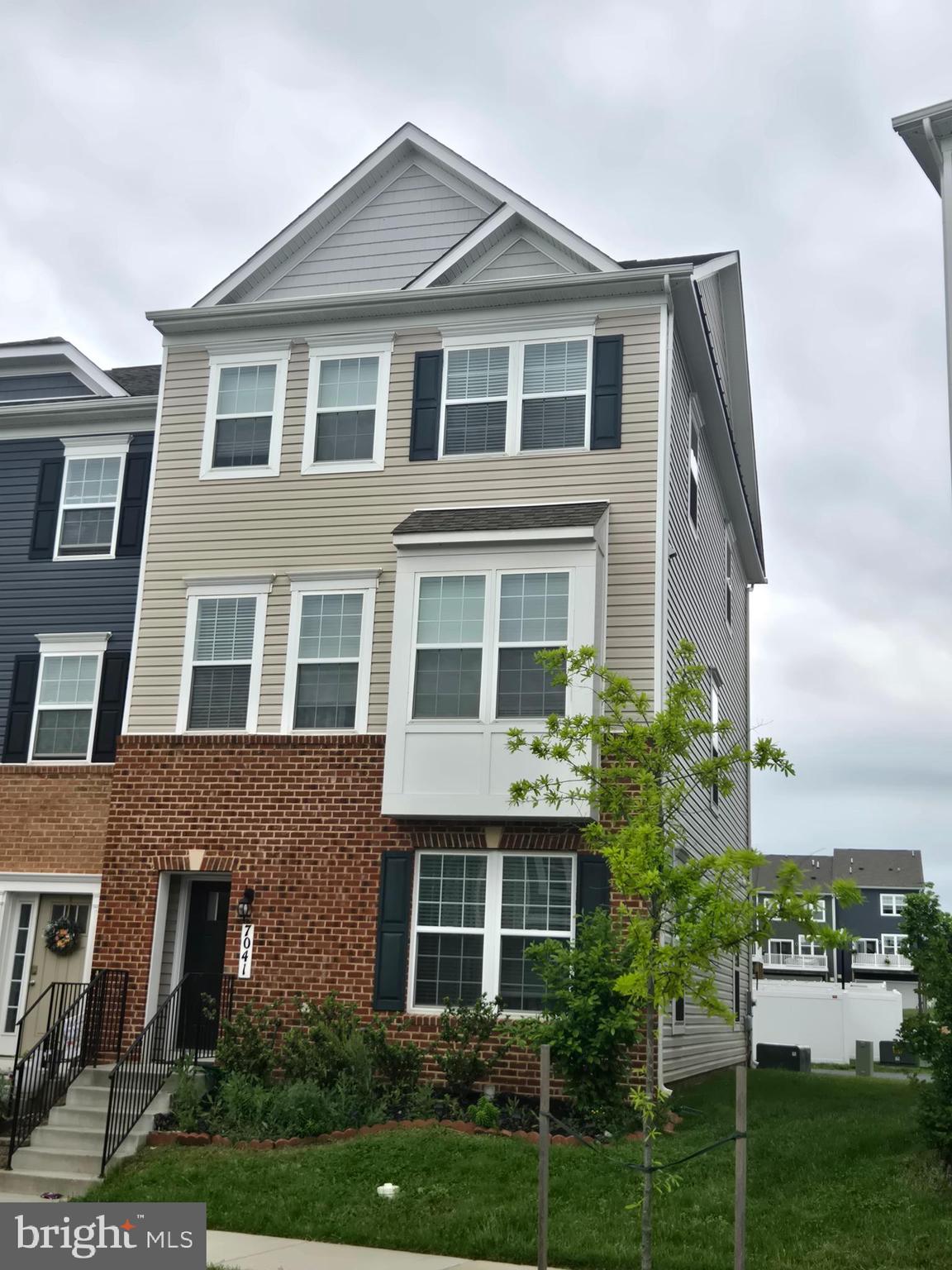 7041 Freedom Way Frederick, MD 21703 - Photo 32 of 32 a front view of a residential apartment building with a yard