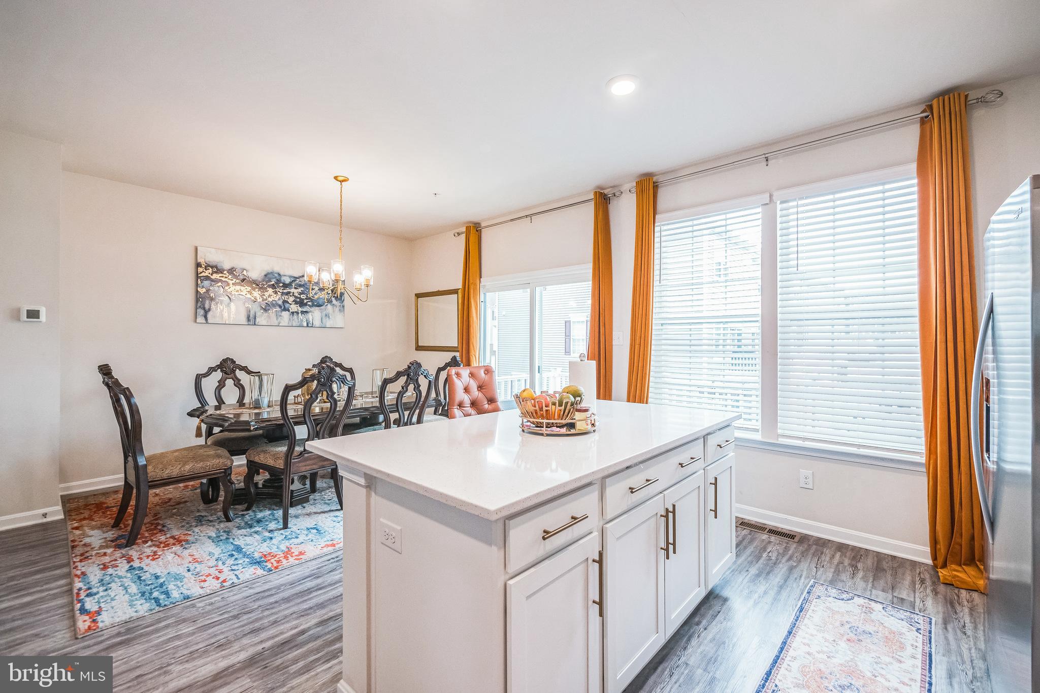 7041 Freedom Way Frederick, MD 21703 - Photo 4 of 32 a view of a kitchen area with furniture and wooden floor