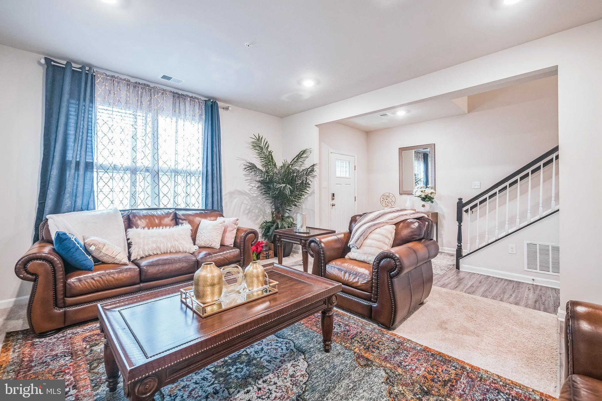 7041 Freedom Way Frederick, MD 21703 - Photo 7 of 32 a living room with furniture a rug and a window