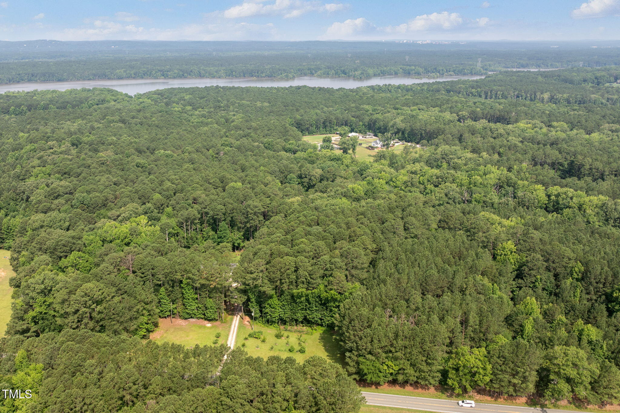 7571 Highway 751 Durham, NC 27713 - Photo 10 of 11 a view of a field with an ocean and trees in the background