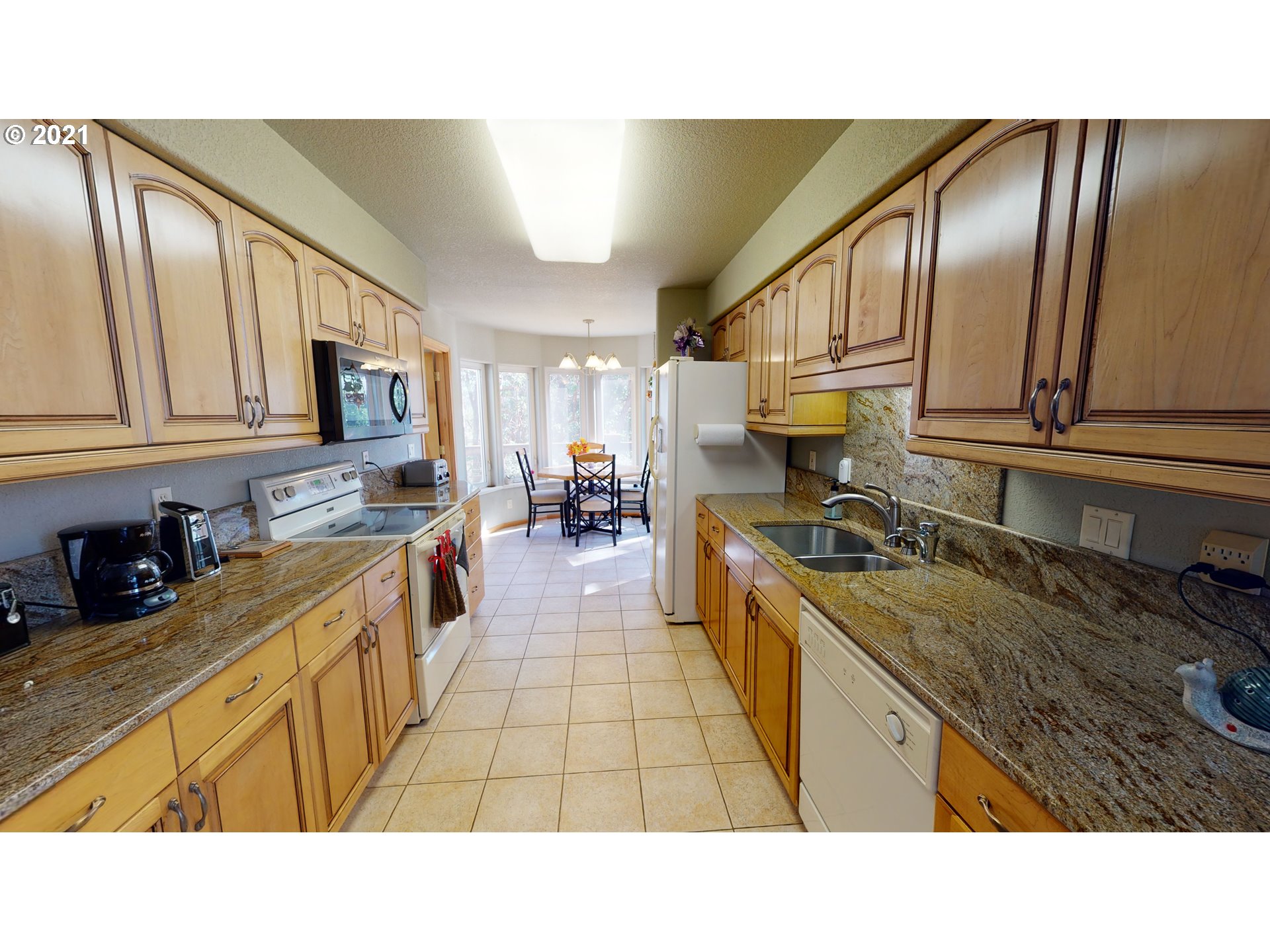 1265 Evergreen Ridge Road Riddle, OR 97469 - Photo 14 of 32 a kitchen with stainless steel appliances granite countertop a sink counter space cabinets and a stove
