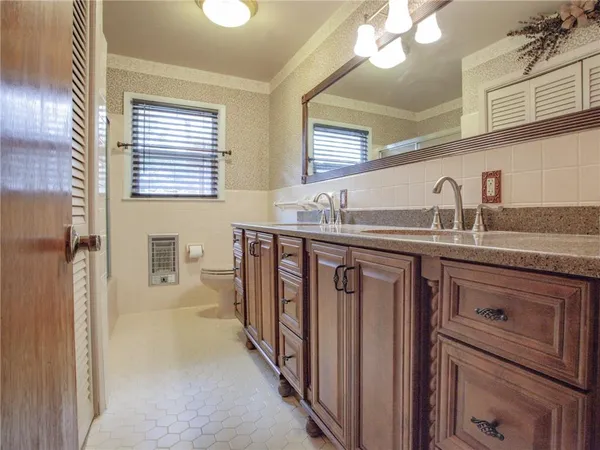 a bathroom with a sink a vanity and a mirror