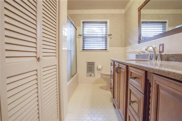 a bathroom with a sink a mirror and shower