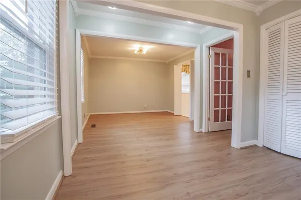 a view of a hallway with wooden floor and staircase