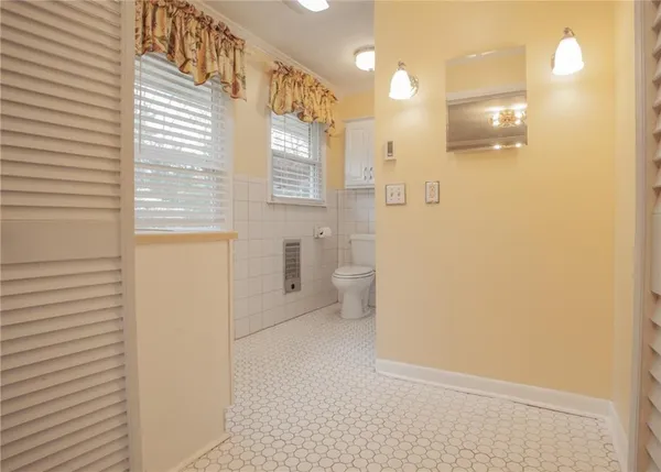 a bathroom with a sink a toilet and a shower
