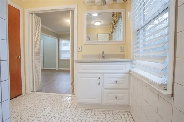 a bathroom with a vanity a sink and a mirror