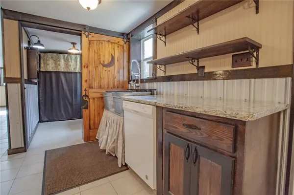 a kitchen with stainless steel appliances granite countertop a sink and cabinets