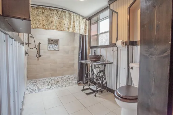 a bathroom with a toilet and a shower