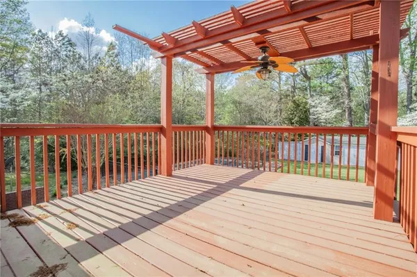 a balcony with wooden floor and fence