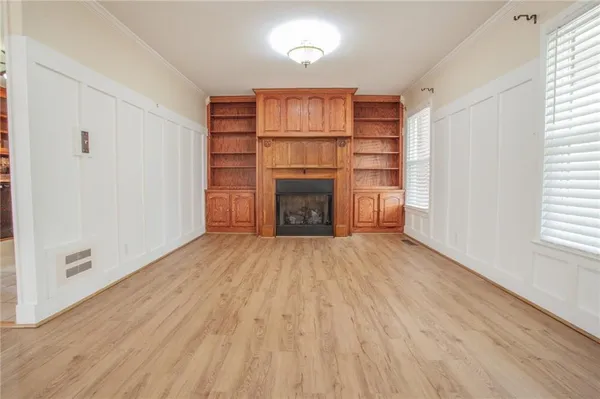 a view of a livingroom with a fireplace and window