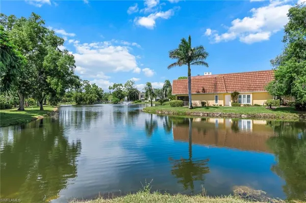 a lake view with a house in the background