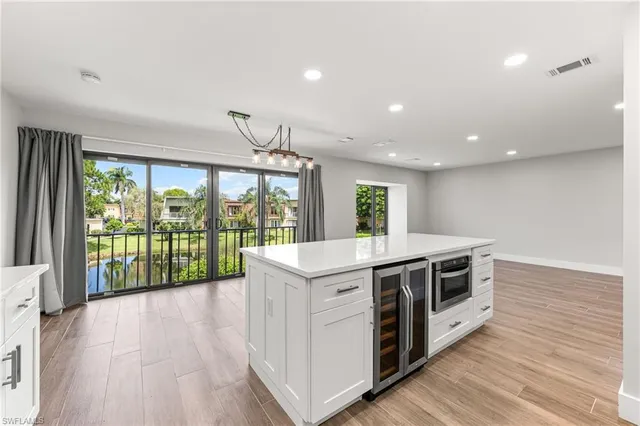 a kitchen with stainless steel appliances a refrigerator sink and microwave