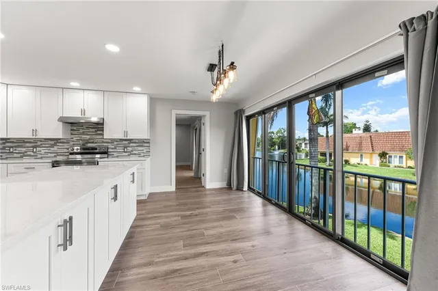 a kitchen with a stove and a large window