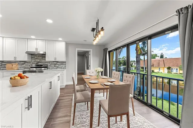 a large kitchen with granite countertop a large window