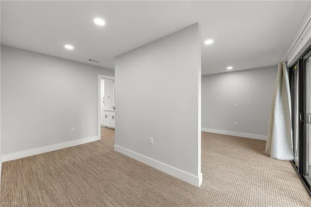 a kitchen with a large window and white appliances