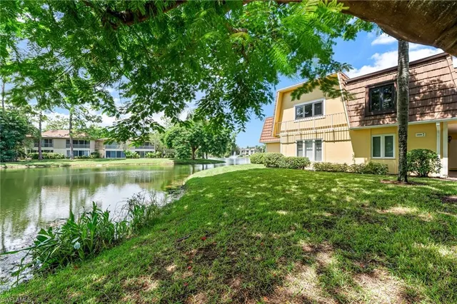a view of a house with a yard and sitting area