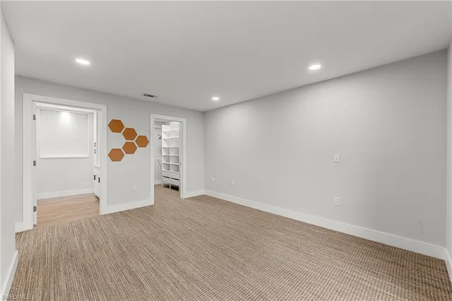 a spacious bedroom with a large bed and a large window