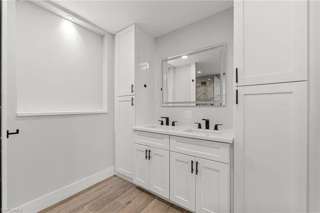 a bathroom with a shower sink and mirror
