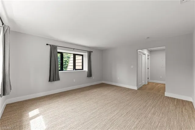 a bedroom with a large bed couch and a window