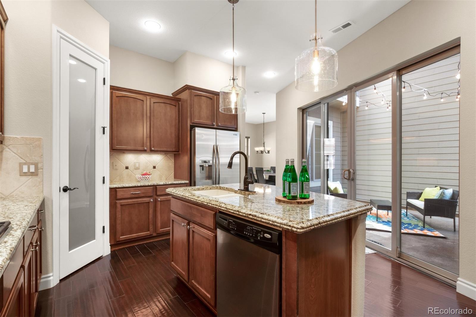 9256 Mornington Way Lone Tree, CO 80124 - Photo 12 of 36 a kitchen with stainless steel appliances granite countertop a sink stove and refrigerator
