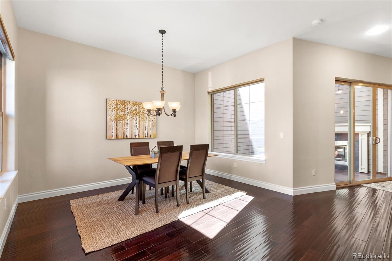 9256 Mornington Way Lone Tree, CO 80124 - Photo 13 of 36 a view of a dining room with furniture window and wooden floor
