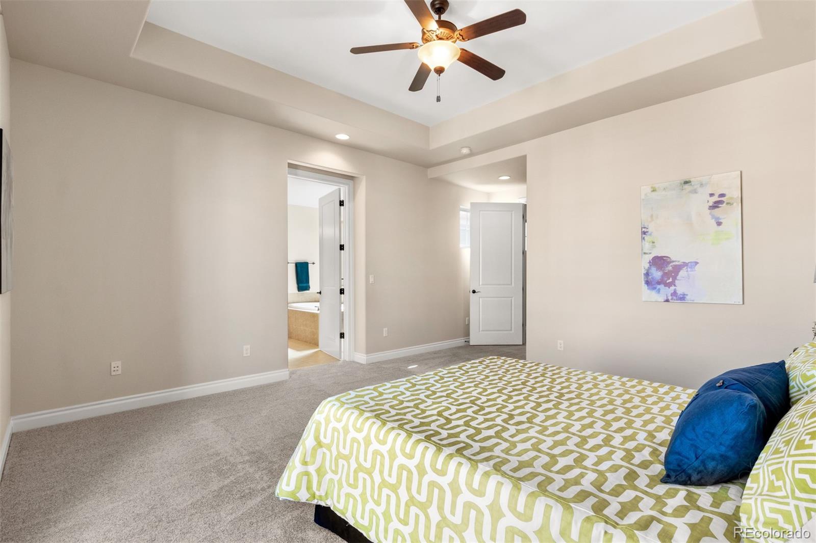9256 Mornington Way Lone Tree, CO 80124 - Photo 20 of 36 a bedroom with a bed and painting on the wall