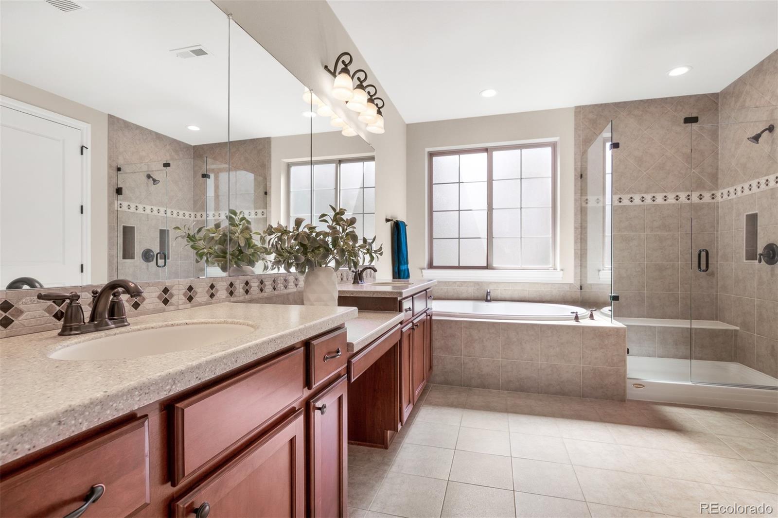 9256 Mornington Way Lone Tree, CO 80124 - Photo 23 of 36 a bathroom with a tub sink and mirror