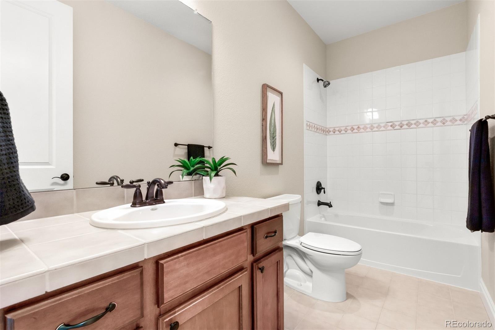9256 Mornington Way Lone Tree, CO 80124 - Photo 27 of 36 a bathroom with a sink a toilet and shower