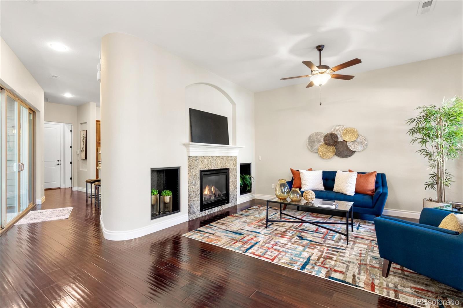 9256 Mornington Way Lone Tree, CO 80124 - Photo 6 of 36 a living room with furniture and a fireplace