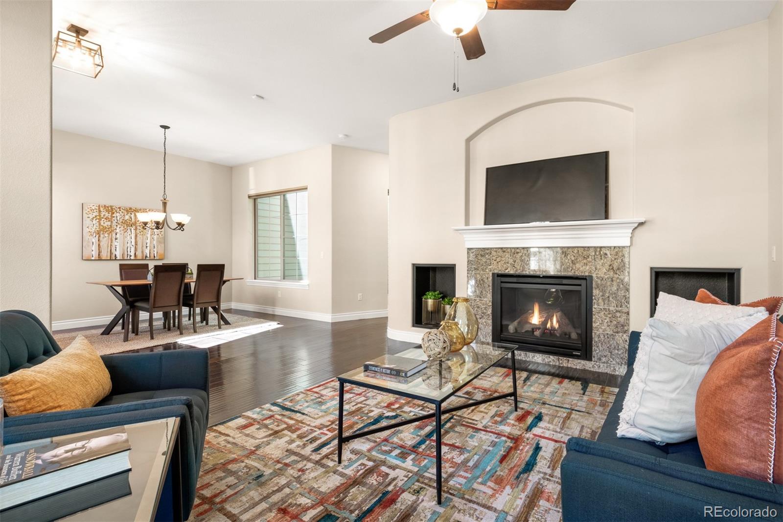 9256 Mornington Way Lone Tree, CO 80124 - Photo 7 of 36 a living room with furniture and a fireplace