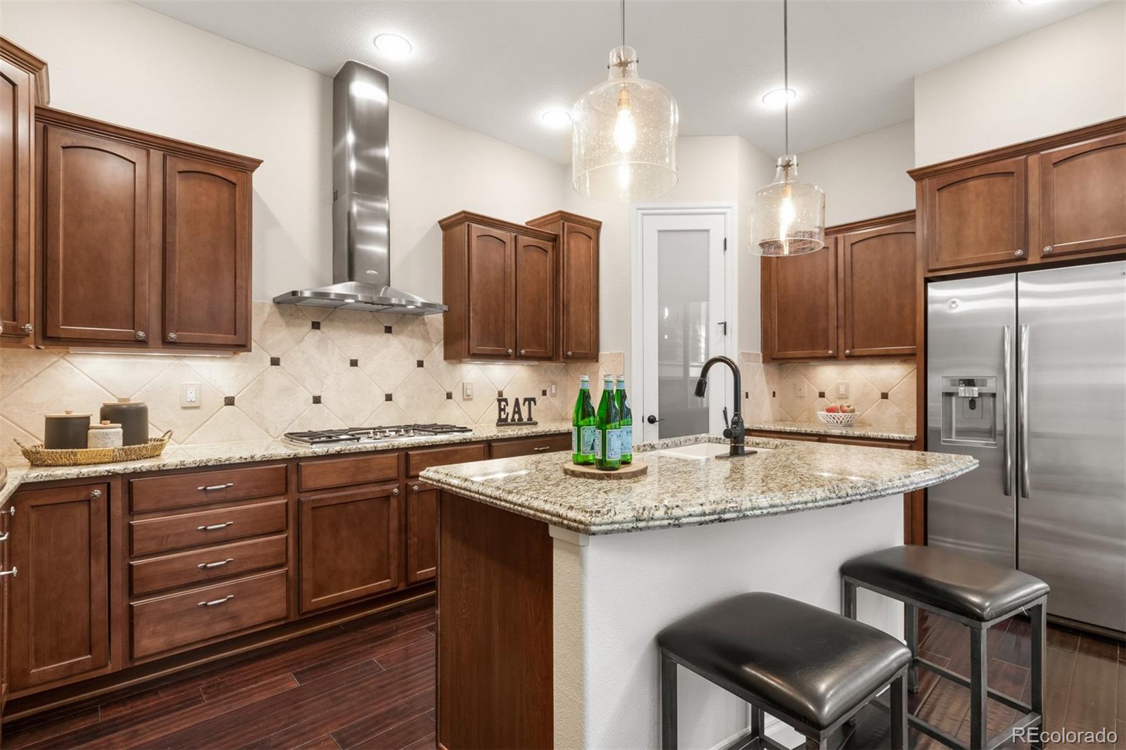 9256 Mornington Way Lone Tree, CO 80124 - Photo 10 of 36 a kitchen with stainless steel appliances granite countertop a sink refrigerator and cabinets