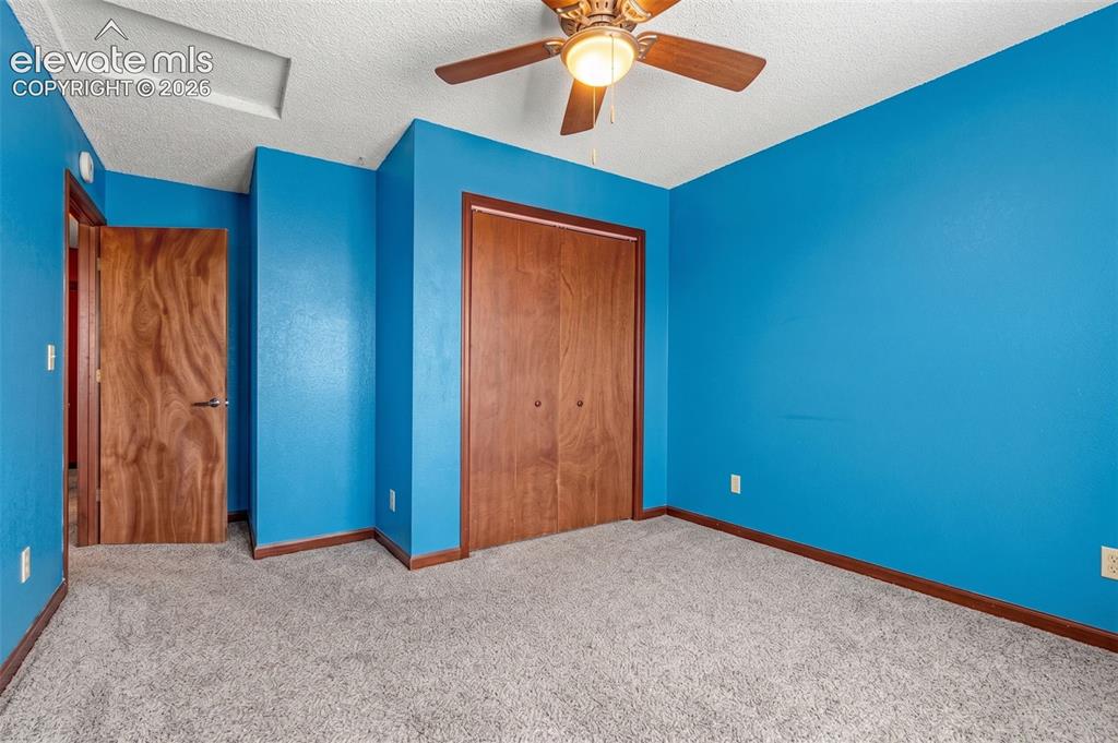613 Wheat Field Road Fountain, CO 80817 - Photo 13 of 32 an empty room with closet and fan