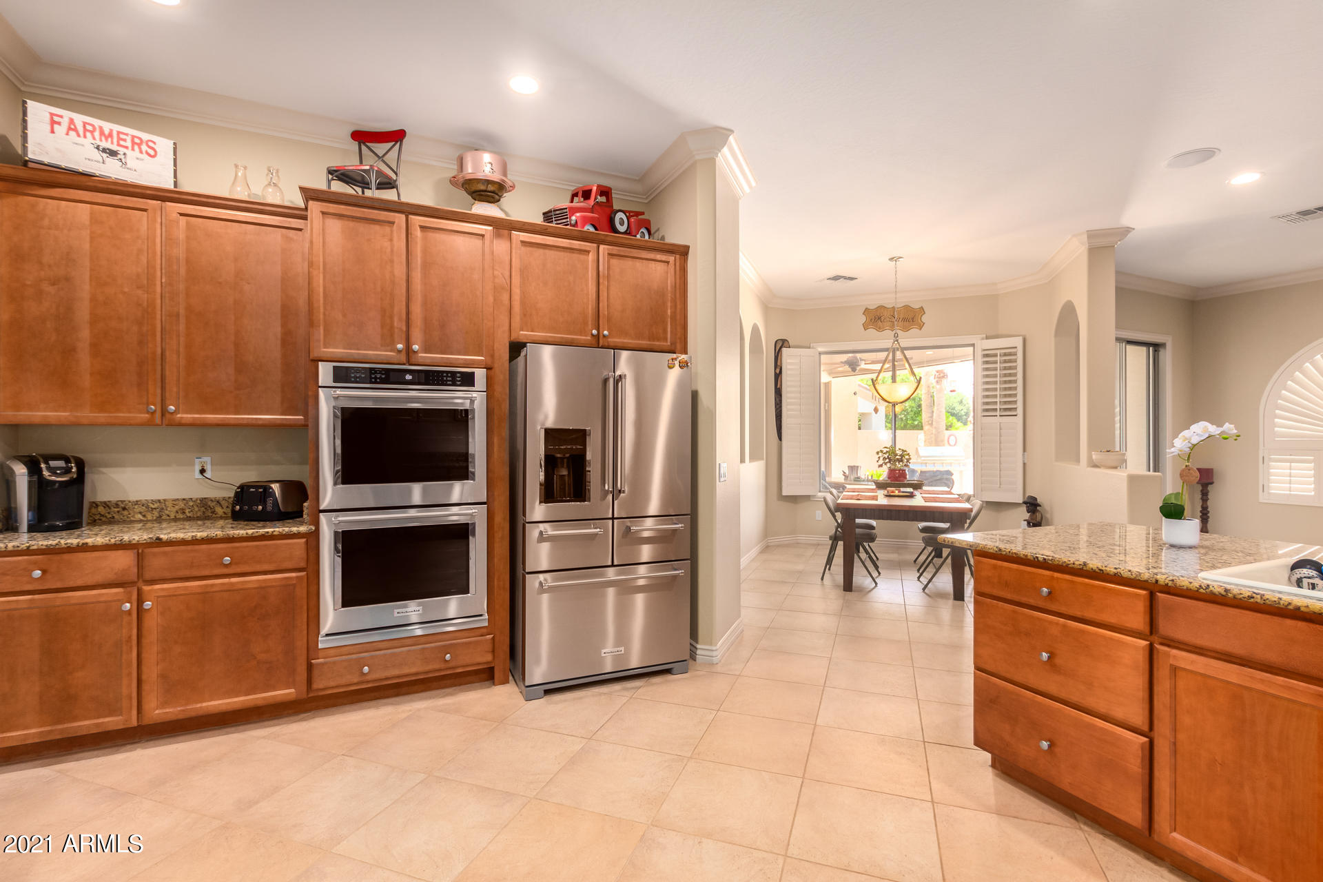 4648 South Ranger Court Gilbert, AZ 85297 - Photo 16 of 49 a kitchen with granite countertop a refrigerator a sink a stove and cabinets