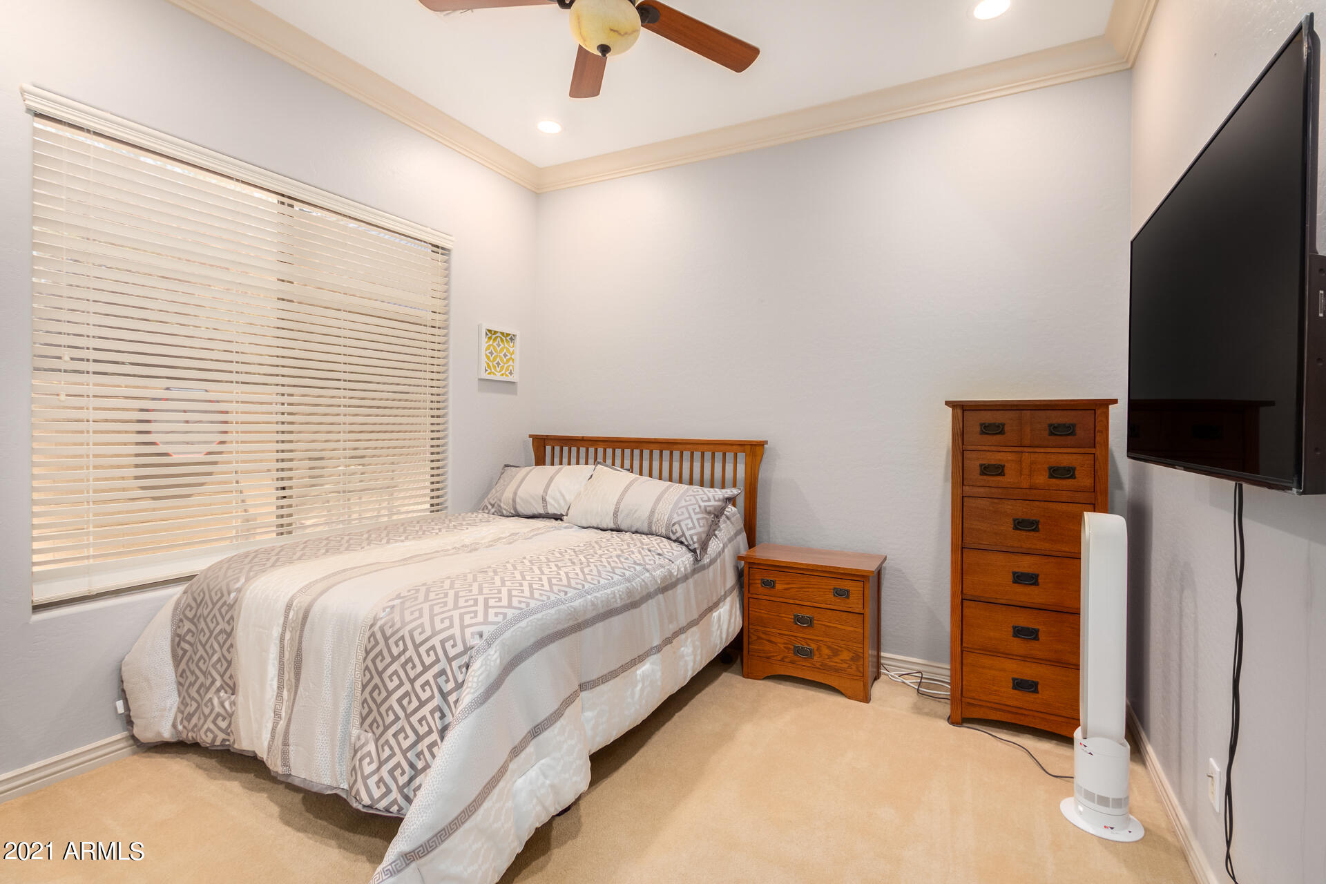 4648 South Ranger Court Gilbert, AZ 85297 - Photo 35 of 49 a bedroom with a bed and a flat tv screen on dresser