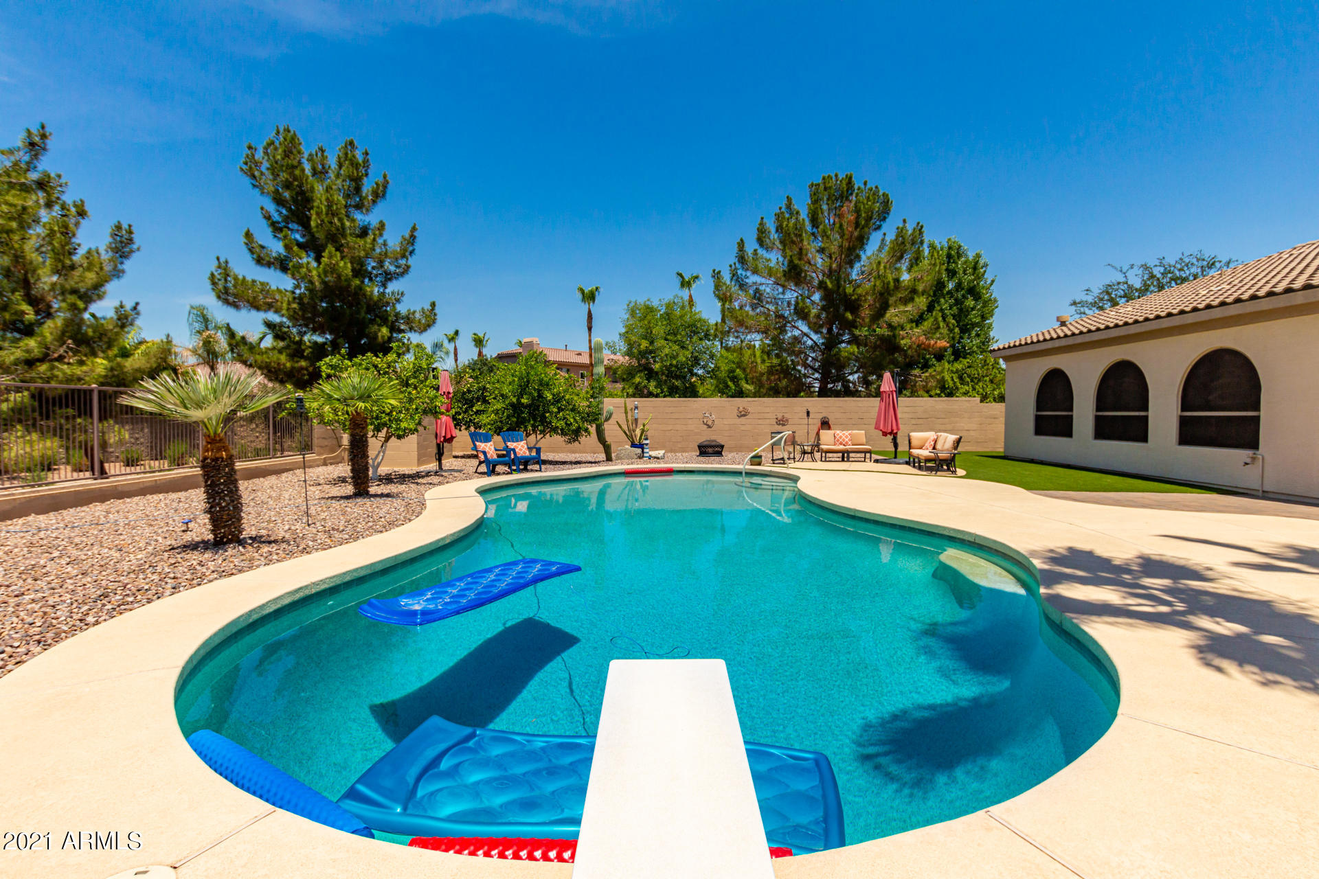 4648 South Ranger Court Gilbert, AZ 85297 - Photo 44 of 49 a swimming pool with outdoor seating and yard