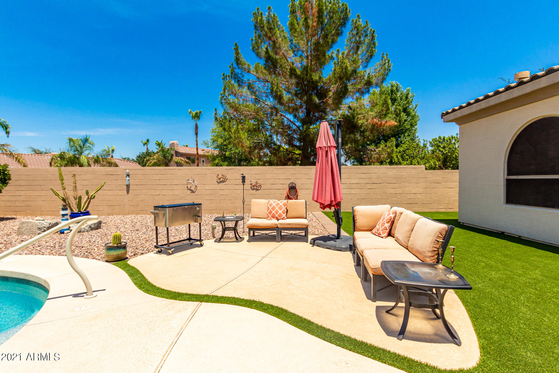 4648 South Ranger Court Gilbert, AZ 85297 - Photo 46 of 49 a view of swimming pool with seating area and trees around