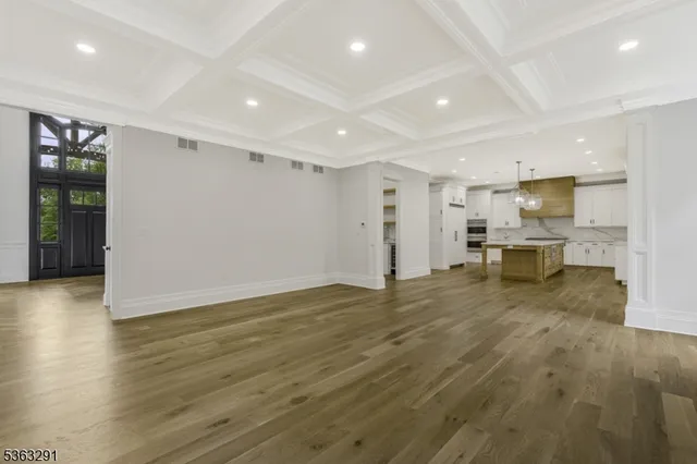 a dining room with furniture large windows and a chandelier