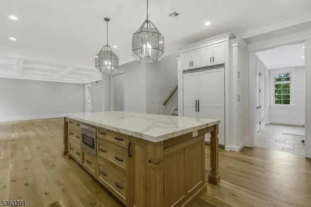 a bathroom with a granite countertop sink a toilet and shower