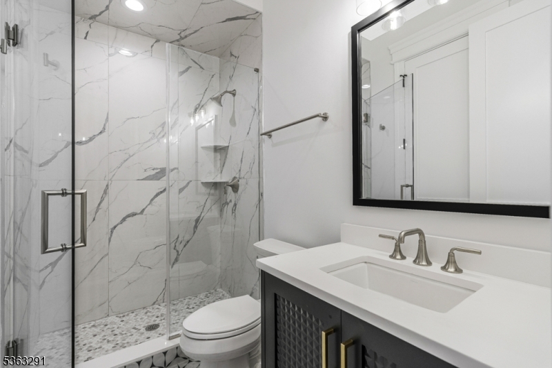 8 Cobblestone Court Warren, NJ 07059 - Photo 33 of 50 a bathroom with a sink toilet vanity and shower